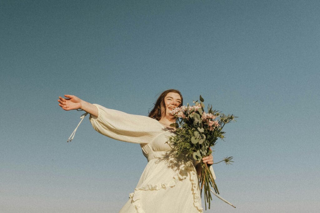 Bride holding bouquet outdoors