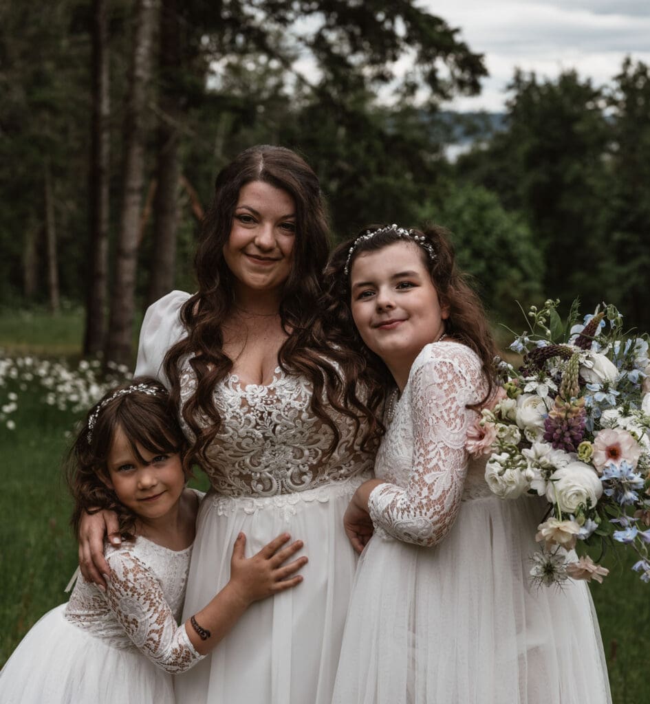 Bride with flower girls in lace dresses