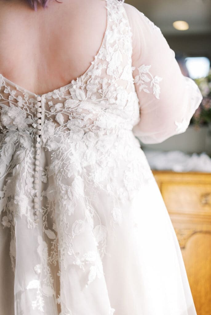 Close-up of lace wedding dress back with buttons